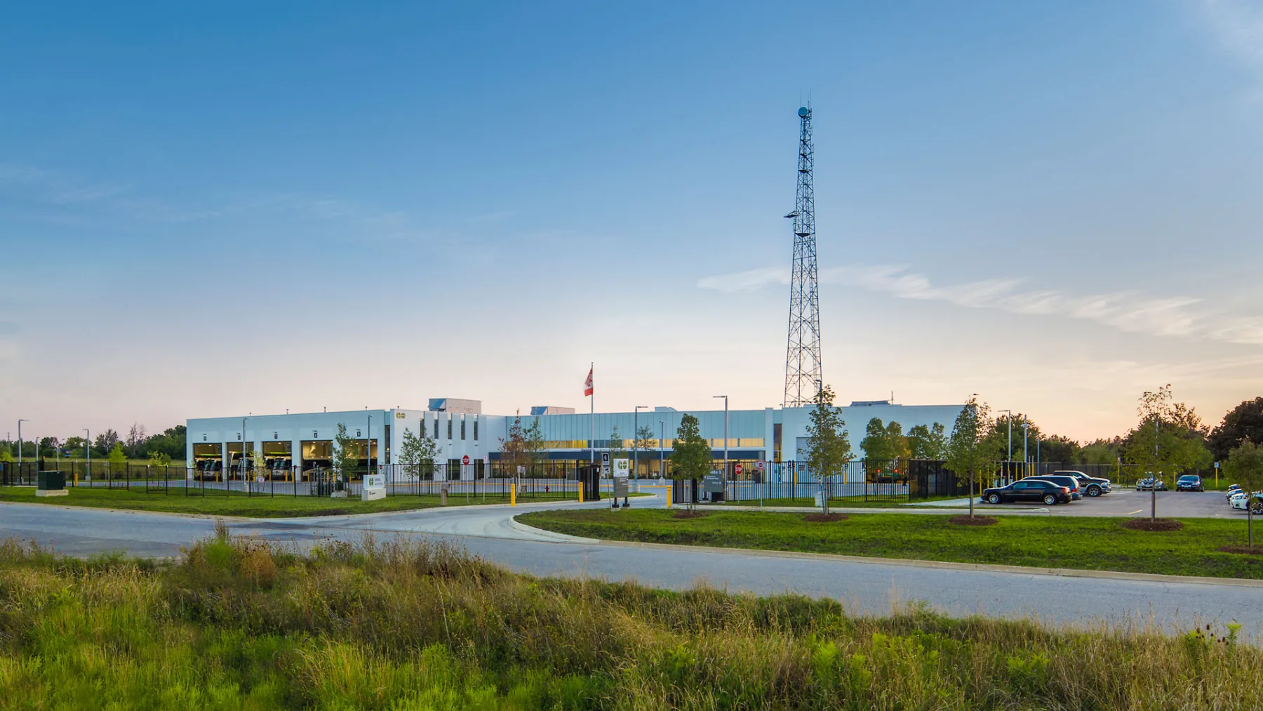 Exterior photo of the facility, showing the entire building, parking lot, landscape and the road
