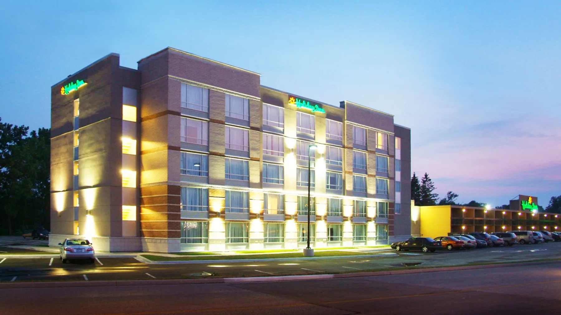 Exterior photo of the Inn with parking lot in the front