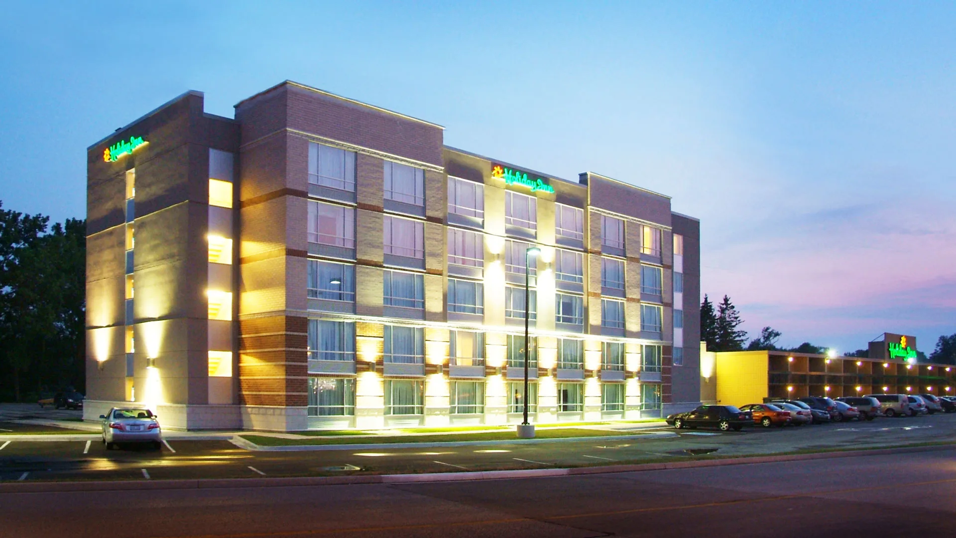 Exterior photo of the Inn with parking lot in the front