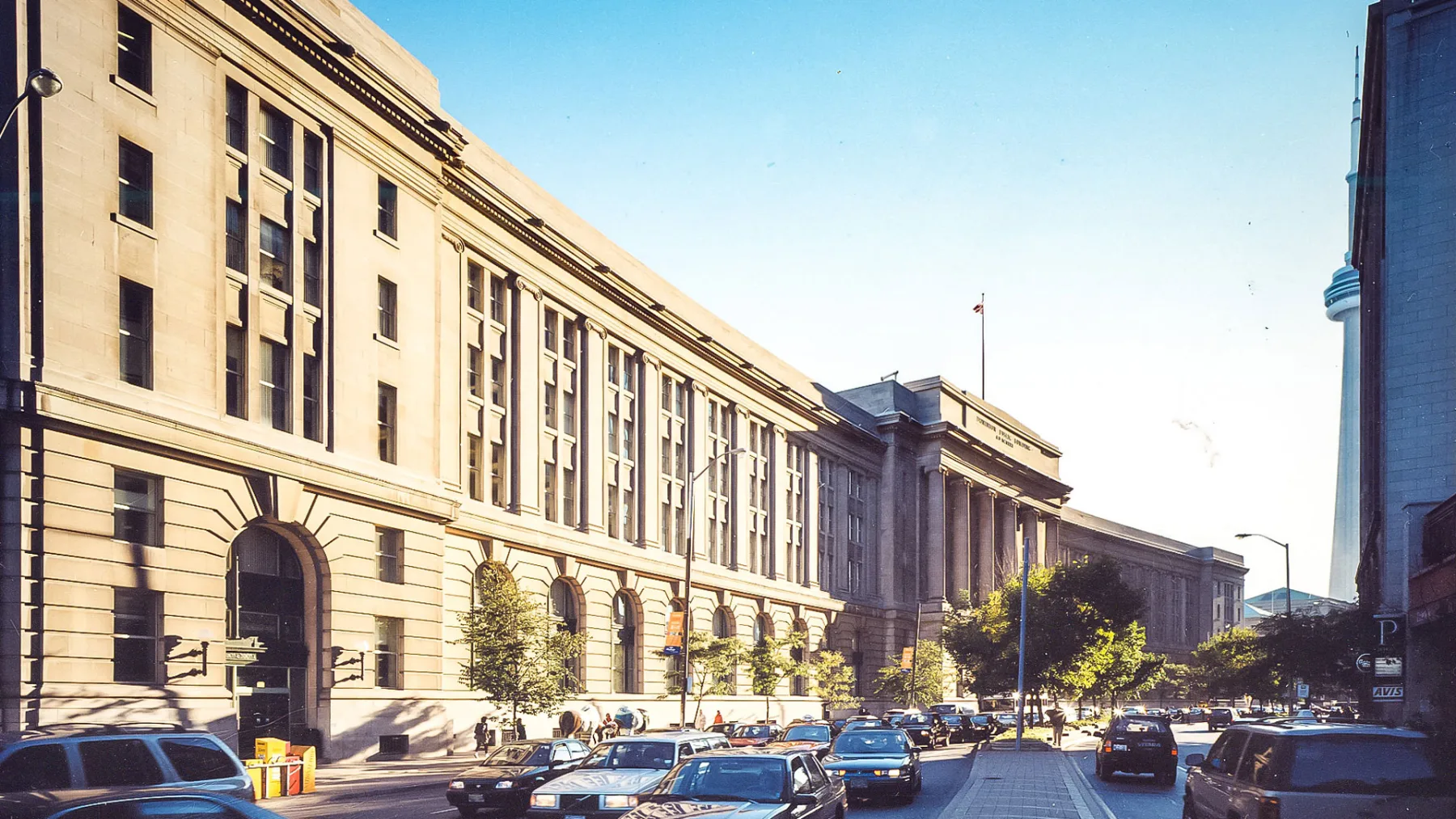 Exterior photo of historic building, with CN Tower in the back