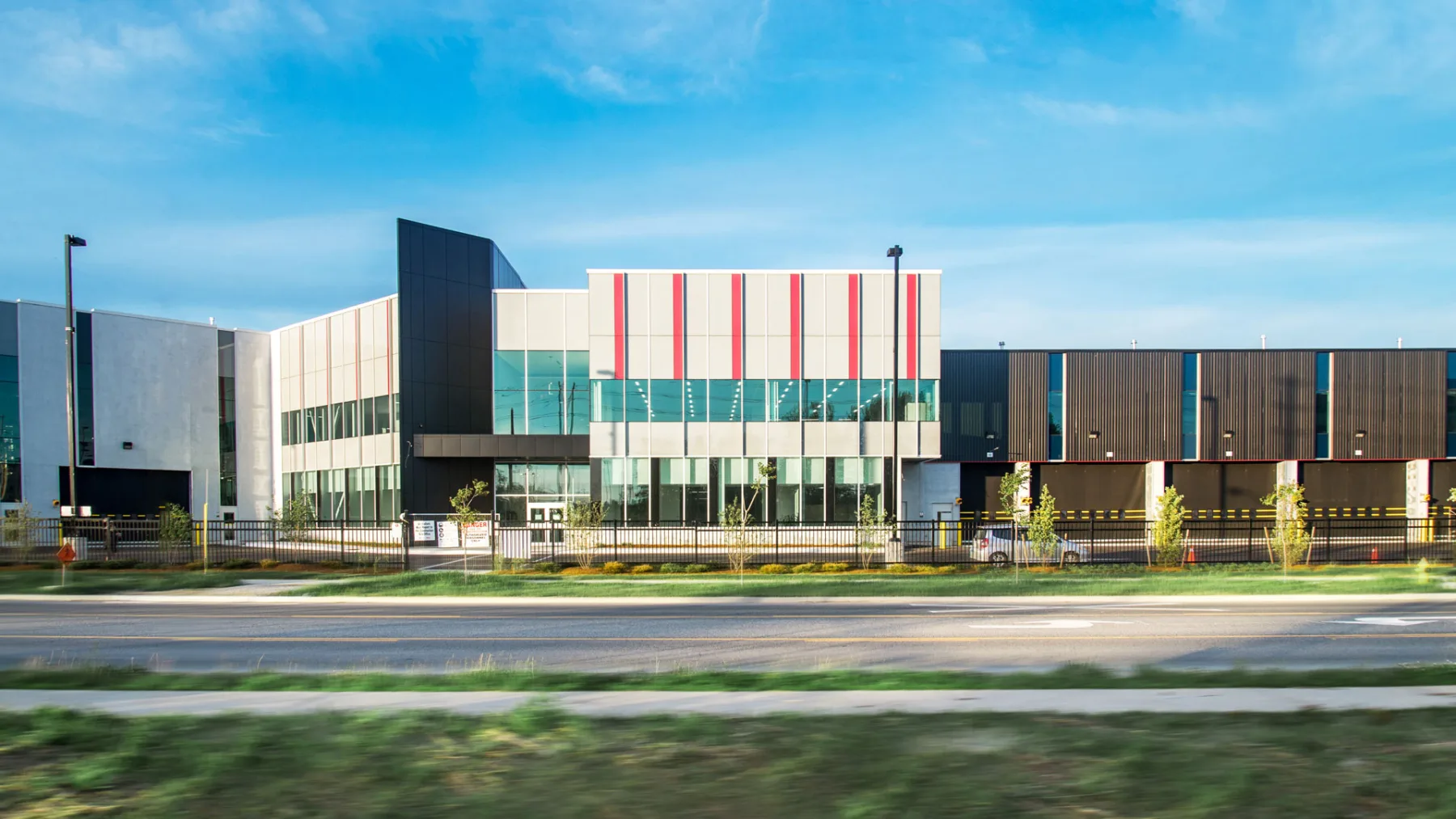 Exterior photo of the facility showing the building entrance and overhead doors