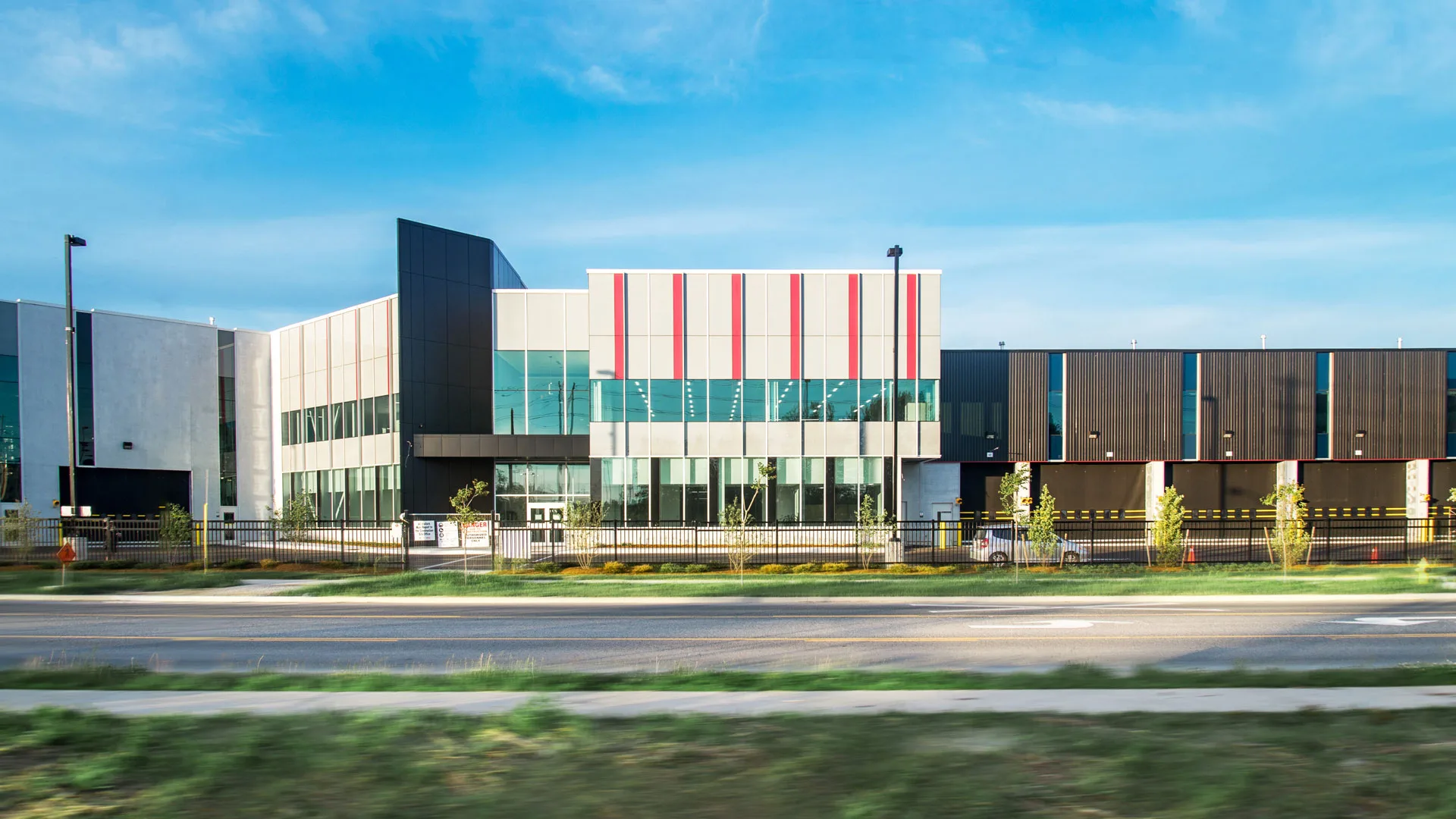 Exterior photo of the facility showing the building entrance and overhead doors