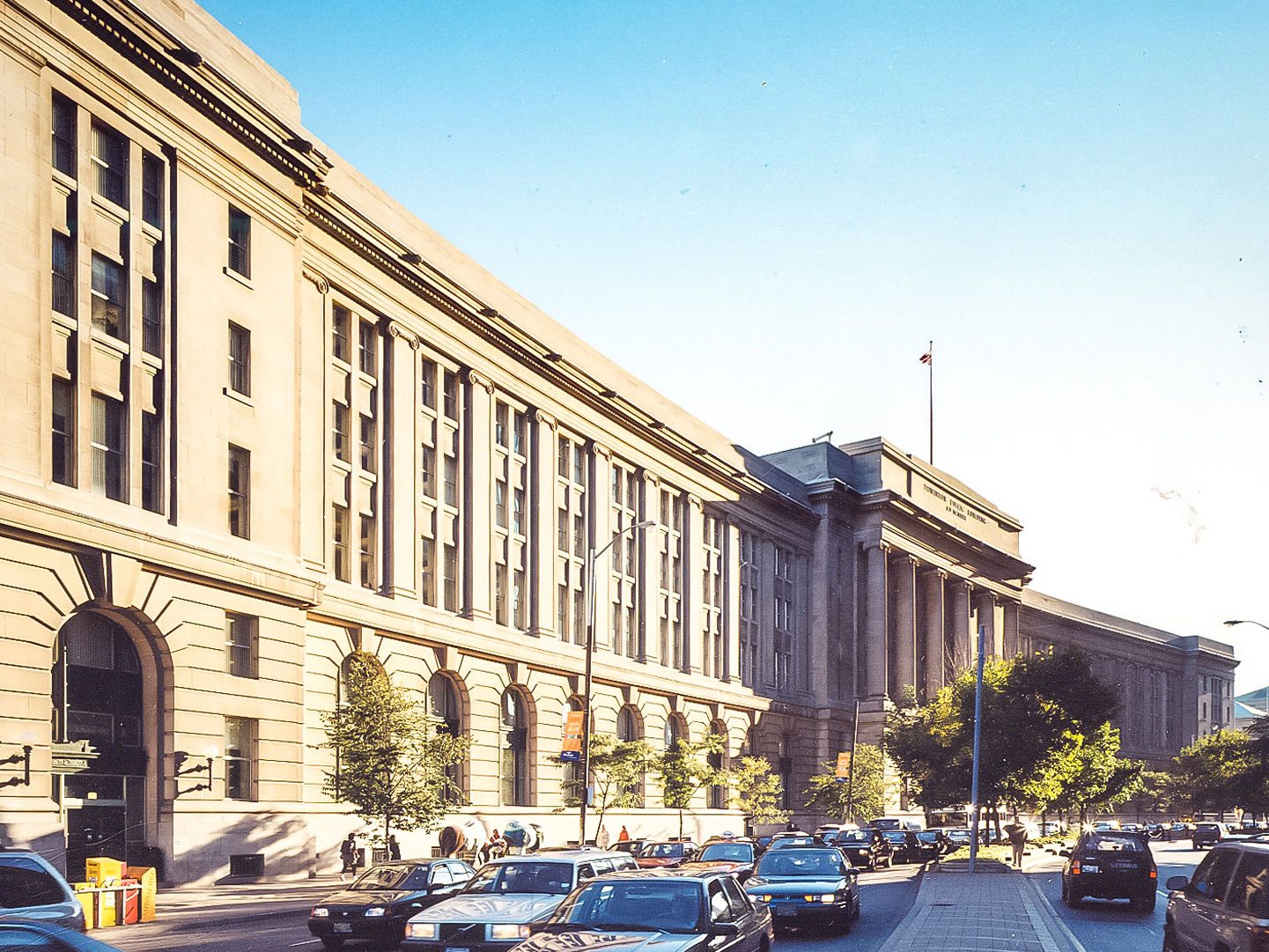 Exterior photo of historic building, with CN Tower in the back